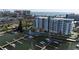 Stunning aerial view of waterfront condos with a pool and marina, offering luxurious coastal living at 411 E Shore Drive # 212, Clearwater Beach, FL 33767