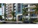 Upscale condo building with modern architecture, lush landscaping, and convenient street access at 411 E Shore Drive # 212, Clearwater Beach, FL 33767