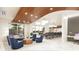 Elegant lobby with waterfront view, marble floors, plush seating, and computer workspace at 411 E Shore Drive # 214, Clearwater Beach, FL 33767