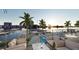 Exterior view from patio featuring pool with lounge chairs and waterfront view and boat docks at 411 E Shore Drive # 309, Clearwater Beach, FL 33767