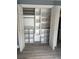 Organized bedroom closet with white shelving and double doors, providing ample storage space at 4127 Dolphin Dr # 4127, Tampa, FL 33617