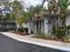 Inviting exterior featuring lush landscaping and mature palm trees by the front entrance at 4127 Dolphin Dr # 4127, Tampa, FL 33617