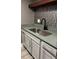 Stylish kitchen sink with granite countertops, white cabinets, and decorative backsplash at 4127 Dolphin Dr # 4127, Tampa, FL 33617