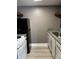 Compact kitchen with stainless steel sink, white cabinets and appliances, and gray countertops at 4127 Dolphin Dr # 4127, Tampa, FL 33617