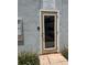 Community office building's exterior entry with signage, door, and landscaping at 4127 Dolphin Dr # 4127, Tampa, FL 33617