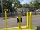 Designated parking with a yellow security device and a fence in the background at 4127 Dolphin Dr # 4127, Tampa, FL 33617