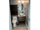 Cozy powder room with a modern vanity, vessel sink, and neutral decor at 4127 Dolphin Dr # 4127, Tampa, FL 33617