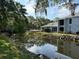 Exterior shows a serene water view with lush green landscaping and a building at 4127 Dolphin Dr # 4127, Tampa, FL 33617