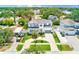 Stunning aerial view of a modern two-story home with a lush front yard and a circular driveway at 4710 W El Prado Blvd, Tampa, FL 33629