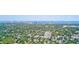 Expansive aerial view showcases a lush, green neighborhood with city skyline in the distance at 4710 W El Prado Blvd, Tampa, FL 33629