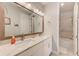 A bright bathroom featuring double sinks, a large mirror, and a view of the shower and toilet area at 4710 W El Prado Blvd, Tampa, FL 33629