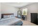 Comfortable bedroom featuring a bed, a desk, and a dresser providing a functional and cozy space at 4710 W El Prado Blvd, Tampa, FL 33629
