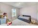 A charming bedroom features a daybed, a soft rug, and a window that offers lots of light and a beautiful view at 4710 W El Prado Blvd, Tampa, FL 33629