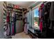 A well-organized walk-in closet offers ample storage with custom shelving and a window for natural light at 4710 W El Prado Blvd, Tampa, FL 33629