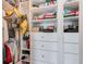 A organized closet featuring white shelving, drawers, and personal belongings, providing ample storage space at 4710 W El Prado Blvd, Tampa, FL 33629