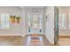 Bright foyer featuring wood floors, decorative rug, and a view of the front door with sidelights at 4710 W El Prado Blvd, Tampa, FL 33629