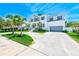 Stunning two-story home with stone accents, a wide driveway, and lush landscaping offering an inviting curb appeal at 4710 W El Prado Blvd, Tampa, FL 33629