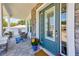 Charming front porch with stone detailing, seating, and a teal door creating a welcoming entrance at 4710 W El Prado Blvd, Tampa, FL 33629