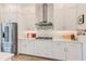Well-organized kitchen boasting stainless steel appliances, marble countertops, and ample white cabinet storage at 4710 W El Prado Blvd, Tampa, FL 33629