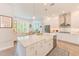 A spacious kitchen showcasing a center island, stainless steel appliances, and an adjacent dining area with ample natural light at 4710 W El Prado Blvd, Tampa, FL 33629