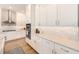 A well-equipped kitchen featuring white cabinets, stone countertops, stainless steel appliances and modern fixtures at 4710 W El Prado Blvd, Tampa, FL 33629
