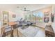 Open-concept living area with large windows, a comfortable sofa, and stylish decor at 4710 W El Prado Blvd, Tampa, FL 33629