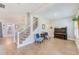 Open-concept living room with hardwood floors, staircase, and views to other rooms at 4710 W El Prado Blvd, Tampa, FL 33629