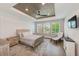 Serene bedroom with tray ceiling, recessed lighting, wood floors, and shuttered windows at 4710 W El Prado Blvd, Tampa, FL 33629