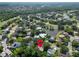 Aerial view of a golf community home surrounded by mature trees and multiple ponds, featuring lush scenery at 495 Palmdale Dr, Oldsmar, FL 34677