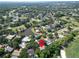 Aerial view of a home in a golf community near a pond, showcasing lush landscapes and mature trees at 495 Palmdale Dr, Oldsmar, FL 34677
