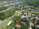 Aerial view of a home within a golf community, boasting mature trees and access to multiple ponds at 495 Palmdale Dr, Oldsmar, FL 34677