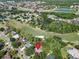 Aerial view of a home with mature trees in a golf community, conveniently located near a highway at 495 Palmdale Dr, Oldsmar, FL 34677