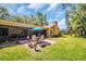 Inviting backyard patio with seating area, lush green lawn, and screened-in porch for relaxed outdoor living at 495 Palmdale Dr, Oldsmar, FL 34677
