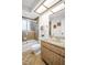 Cozy bathroom with a shower-tub combo, wood-style vanity, and earth-tone flooring and wall tiles at 495 Palmdale Dr, Oldsmar, FL 34677