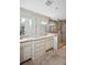Bathroom boasts double sinks, tiled floors, glass shower, and bright vanity lighting at 495 Palmdale Dr, Oldsmar, FL 34677