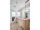 Light and bright bathroom featuring tiled floors, double sinks, and a glass shower at 495 Palmdale Dr, Oldsmar, FL 34677