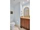 Charming half bathroom with wood vanity, granite countertop, and powder blue painted walls at 495 Palmdale Dr, Oldsmar, FL 34677