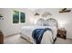 Bright bedroom featuring large window, overhead light, and decorative wall art at 495 Palmdale Dr, Oldsmar, FL 34677