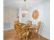 Cozy dining area with a glass-top table, four woven chairs, and a charming light fixture at 495 Palmdale Dr, Oldsmar, FL 34677