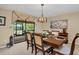 Formal dining room featuring an elegant chandelier, classic furniture, and a view of the screened in patio at 495 Palmdale Dr, Oldsmar, FL 34677