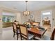 Well-lit dining room featuring a classic chandelier, and furniture, with a seamless transition to adjacent living spaces at 495 Palmdale Dr, Oldsmar, FL 34677