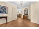 Inviting foyer featuring tiled floors, neutral walls, closet space, and view of the dining area with chandelier at 495 Palmdale Dr, Oldsmar, FL 34677