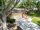 Lovely front yard with green grass and mature trees, leading to an attached two car garage at 495 Palmdale Dr, Oldsmar, FL 34677