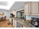 Updated kitchen featuring granite countertops, stainless steel appliances, and ample natural light at 495 Palmdale Dr, Oldsmar, FL 34677