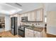 Modern kitchen with stainless steel appliances, granite countertops, and stylish cabinetry at 495 Palmdale Dr, Oldsmar, FL 34677
