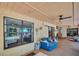 Enclosed lanai features a ceiling fan and comfortable seating, with views of the lush backyard at 495 Palmdale Dr, Oldsmar, FL 34677
