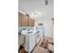 Spacious laundry room featuring a washer, dryer, and ample cabinet storage at 495 Palmdale Dr, Oldsmar, FL 34677
