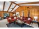Inviting living room featuring wood-paneled walls, vaulted ceilings with beams, and comfortable seating arrangement at 495 Palmdale Dr, Oldsmar, FL 34677