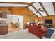 Comfortable living room featuring wood-paneled walls, beamed ceilings, and an open layout to the kitchen at 495 Palmdale Dr, Oldsmar, FL 34677
