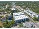 A fantastic aerial view of a white three-story apartment complex; near other apartments, homes, businesses, and lush trees at 5008 S Macdill Ave # 10, Tampa, FL 33611